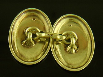 Art Deco scroll-and-pinstripe cufflinks crafted in 14kt gold. (J8632)
