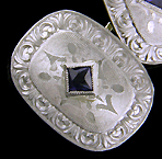 Elegantly engraved platinum and sapphire cufflinks. (J8973)